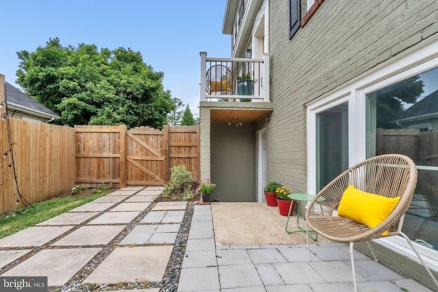 Fenced backyard with stone patio