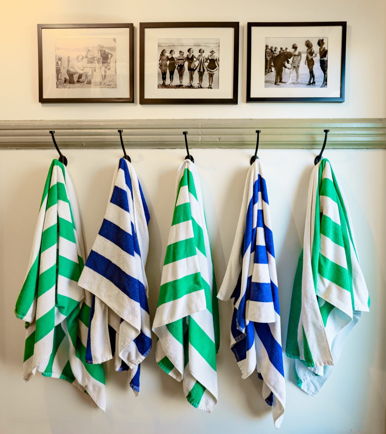 A row of colorful towels on hooks at the Craven House